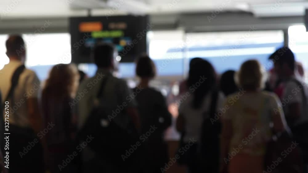 People stand in line to board flight at airport terminal