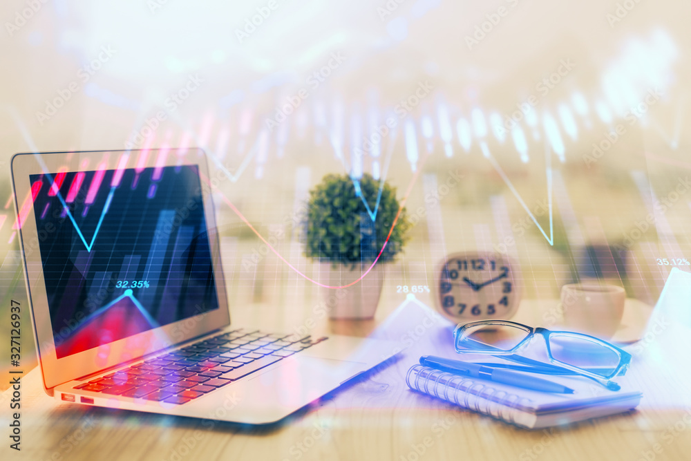 Obraz premium Forex graph hologram on table with computer background. Multi exposure. Concept of financial markets.