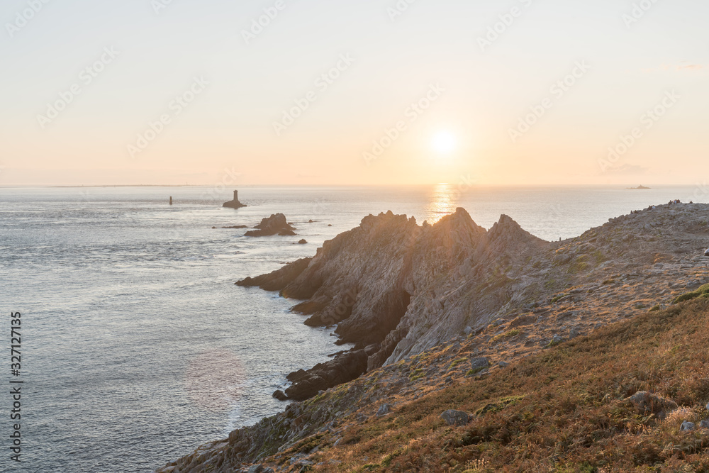 Sunset landscapes at the Raz Point (Pointe du Raz) with cliffs into the sea, Brittany, France Sunset landscapes at the Raz Point (Pointe du Raz) with cliffs into the sea, Brittany, France