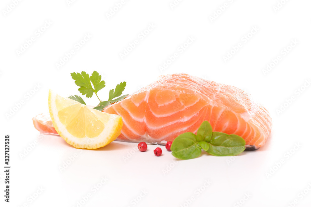 raw salmon fillet with lemon and basil isolated on white background