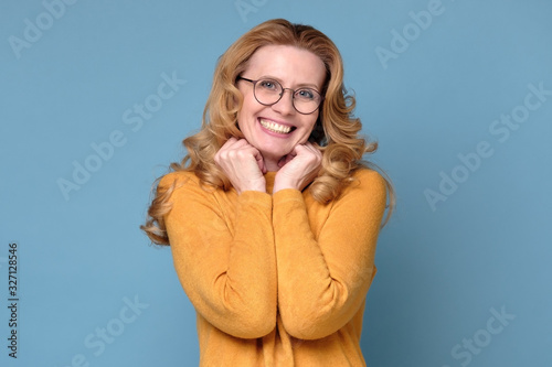 Portrait of a happy smiling woman with arms folded on gray background