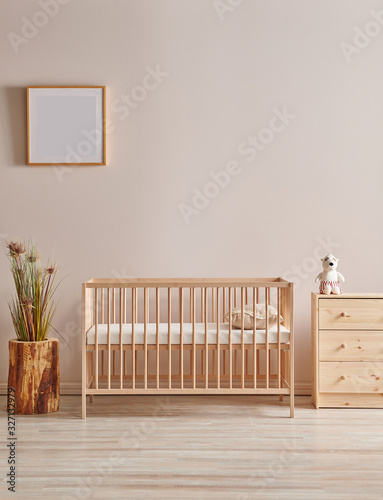 Baby room cradle and crib, bed with frame and lamp concept, pink wall background. photo