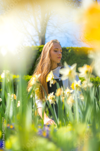 Lifestyle, a Caucasian blonde among yellow and white spring flowers