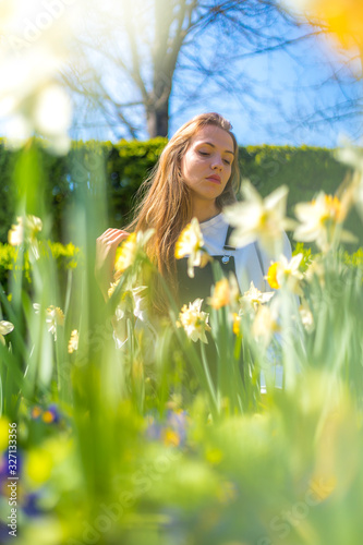 Lifestyle, a Caucasian blonde among yellow spring flowers