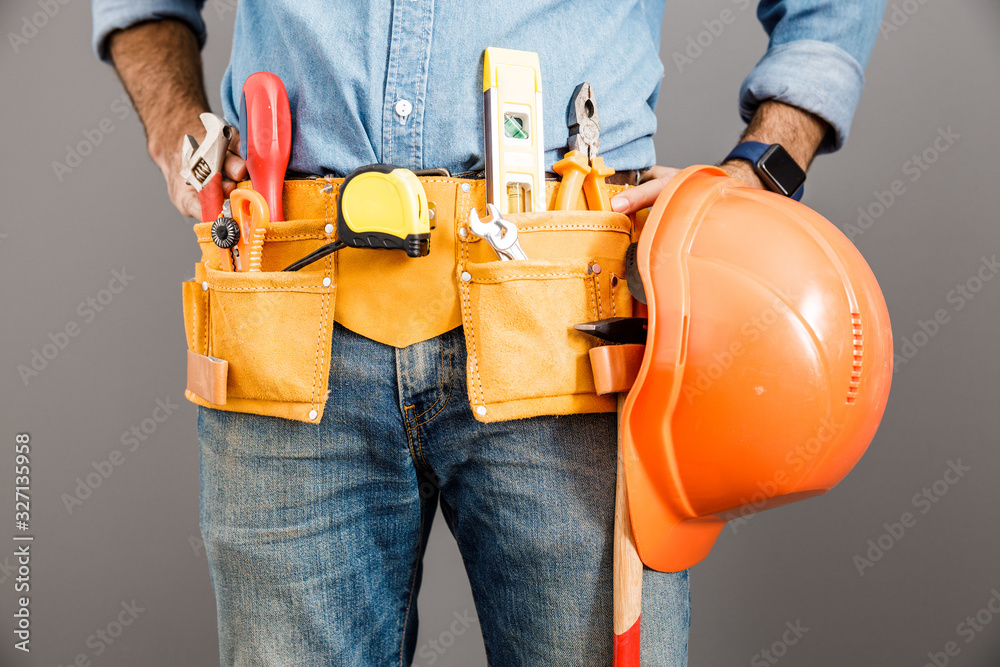 Builder with belt of hand tools stock photo Builder with belt of hand tools stock photo