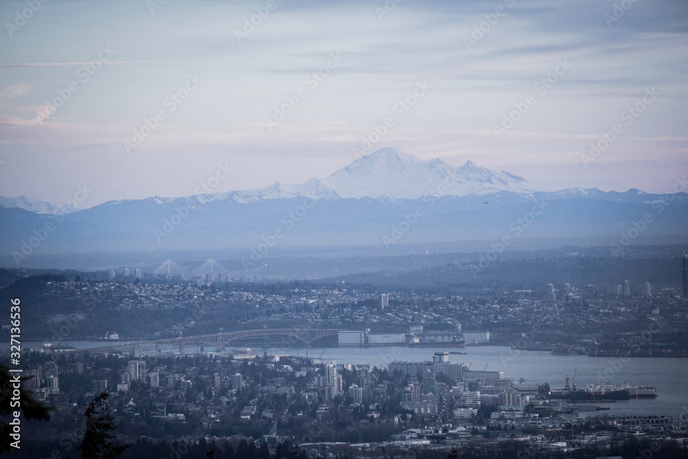 picture of a mountain close to the city with covered peaks in snow and river beautiful mt Baker from Vancouver Canada Washington state USA 