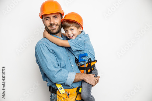 Joyful handyman embracing with son stock photo photo