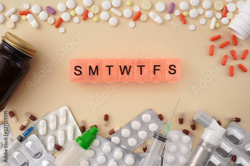 Wallpaper Mural Daily pill box with medications and nutritional supplements. Vitamins, pills blister packs medical bottle, asthma inhaler on yellow background. Medical, pharmacy and healthcare concept. Torontodigital.ca