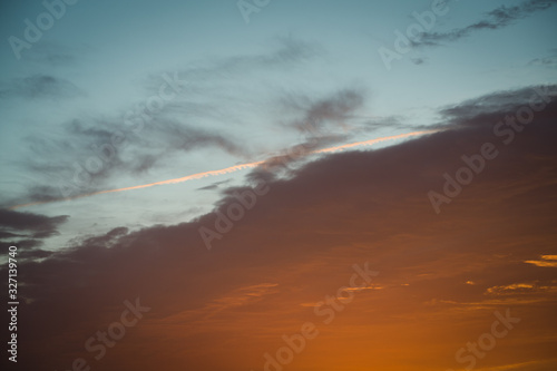 Orange burning clouds on a morning sunrise cloudscape sky