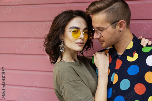 Young fashionable couple on pink background