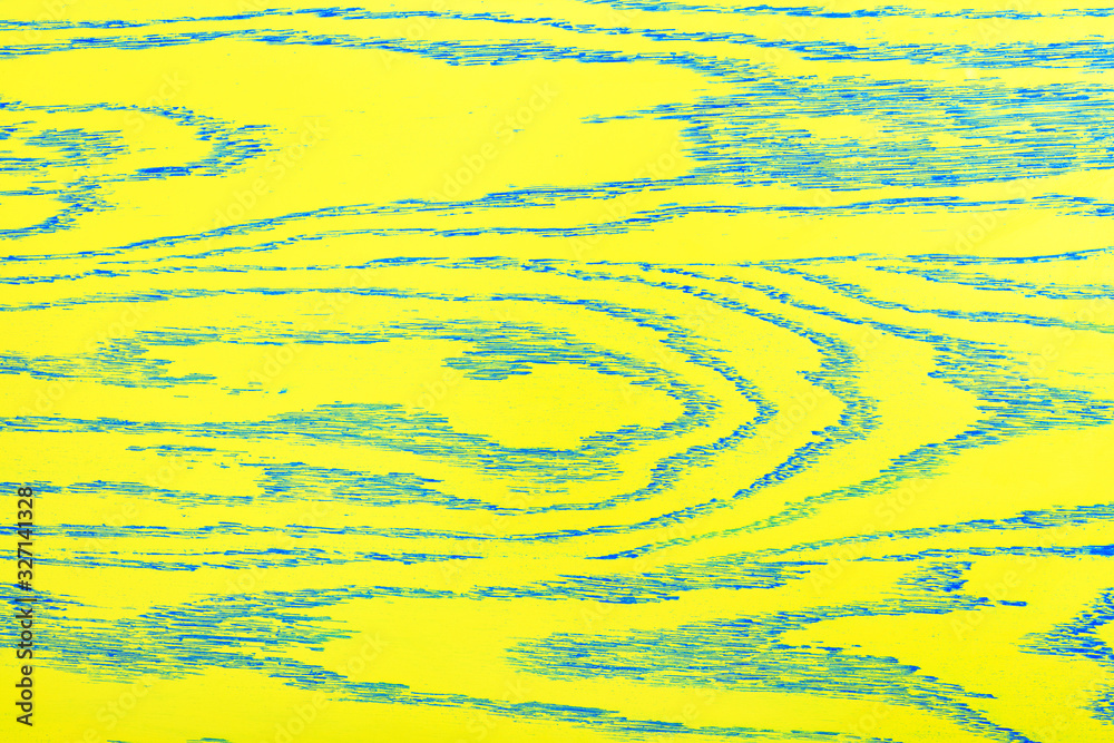 The bright yellow color of the wooden texture with blue veins.