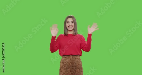 Friendly girl waving hand smiling greeting welcoming photo