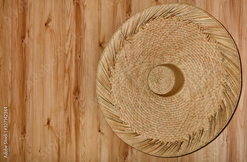 Rattan sombrero hanging on a natural wooden wall photo