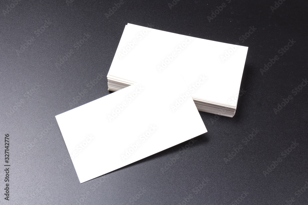 white blank business cards isolated on black background. close-up white blank business cards isolated on black background. close-up