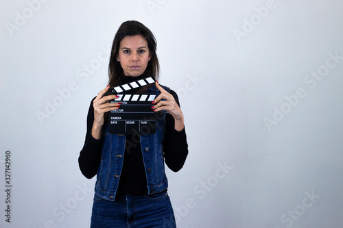 serious  middle age woman with clipper board, long face, with a serious look on his face, isolated on gray background studio shotblack sweater, denim jacket, jeans. Place for your text in copy space. photo