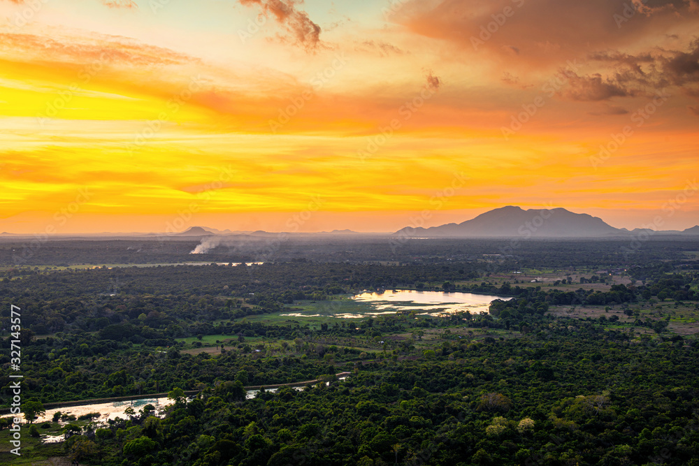 Sunset over the forest and mountains in Sigiriya, Sri Lanka