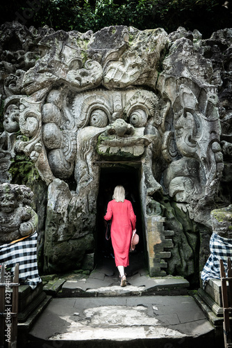 Female tourist entering Goa Gajah cave photo