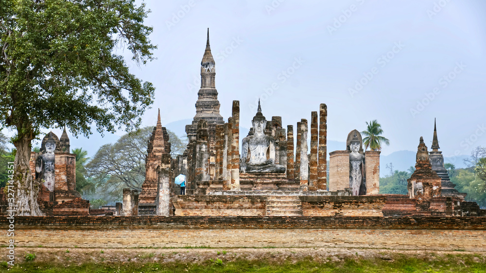 Fototapeta premium Ruins of Ancient Thai Temples. Famous Sukhothai Historical Park, a UNESCO World Heritage Site. The ancient capital of Sukhothai, Thailand