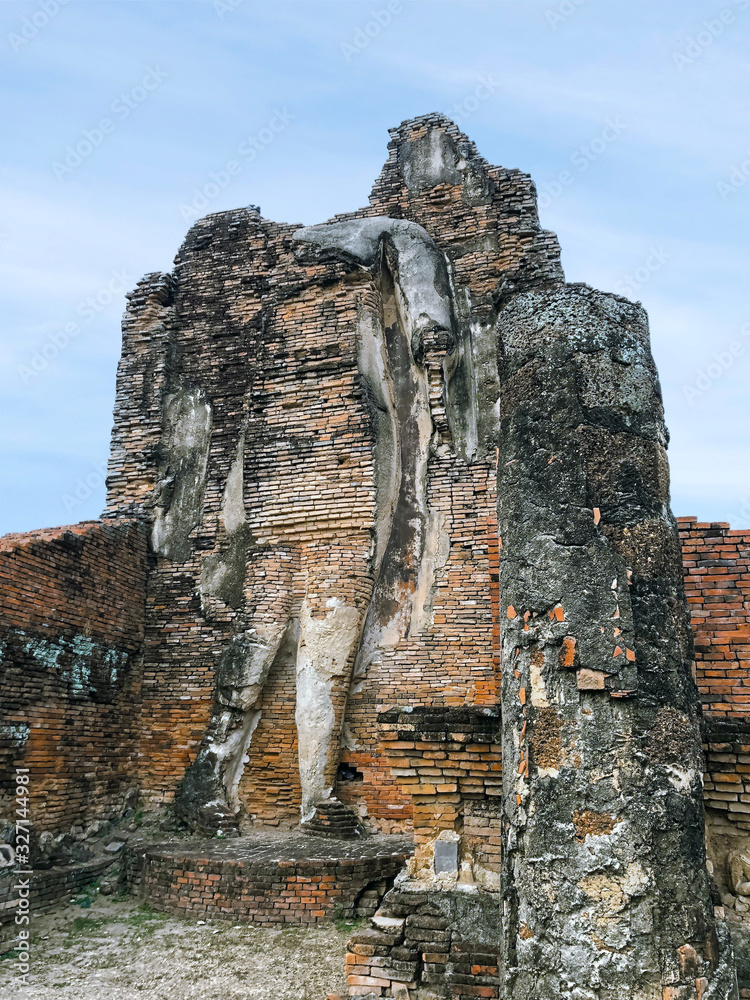 Fototapeta premium Buddha statues of Ancient Thai Temple (Wat Phra pai Luang). Famous Sukhothai Historical Park, a UNESCO World Heritage Site. The ancient capital of Sukhothai, Thailand
