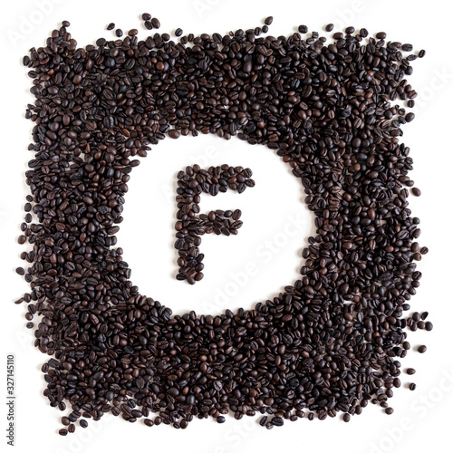 Letter F made out of aromatic coffee beans, top view, isolated on white background. Letter from word Coffee.