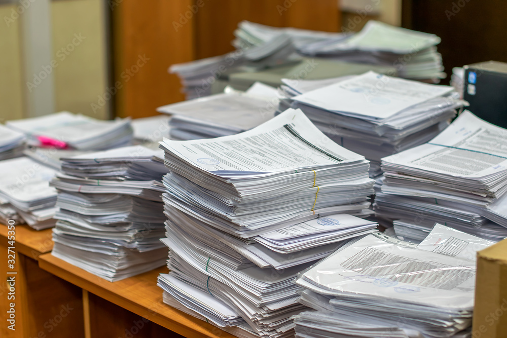 bundles bales of paper documents. stacks packs pile on the desk in the office bundles bales of paper documents. stacks packs pile on the desk in the office
