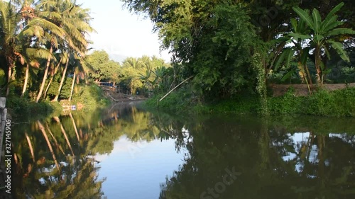 View landscape and movement water of canal in farming garden and coconuts plantation at Samutsongkram, Thailand photo