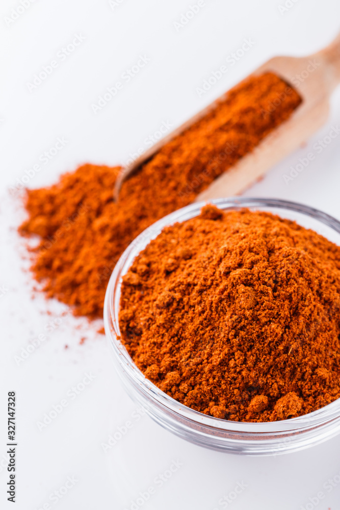 aromatic spicy chili powder on a white background aromatic spicy chili powder on a white background