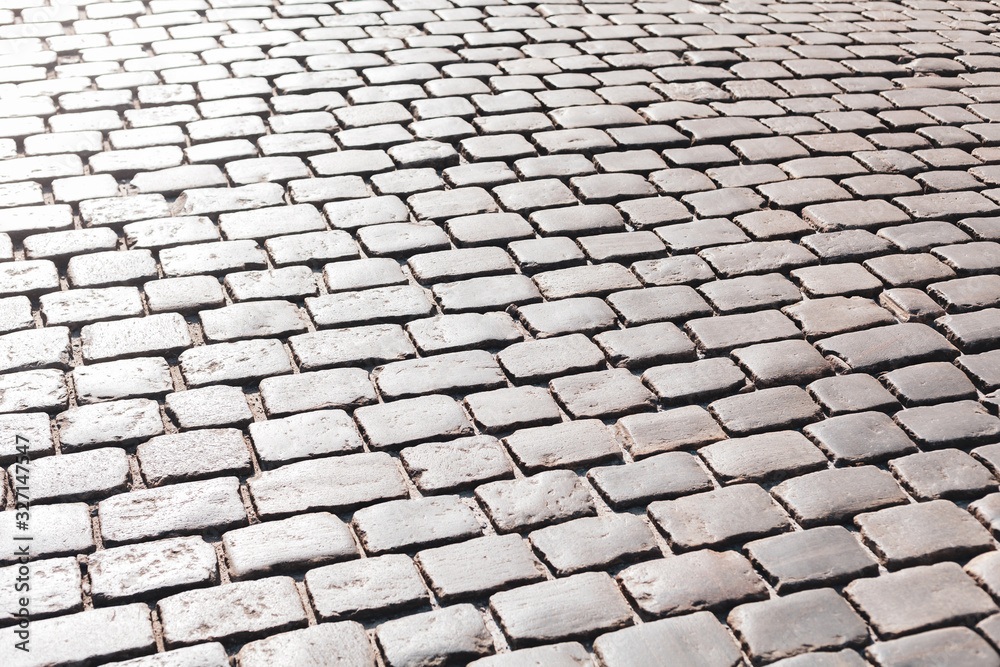Simple grey convex square stone pavement surface, paving, causeway outdoors background texture, light reflections Sidewalk, promenade cobblestone floor, street, road outside top view pattern copyspace