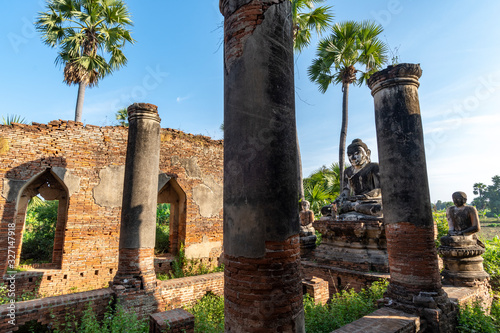 Buddha statue in midst of temple ruins