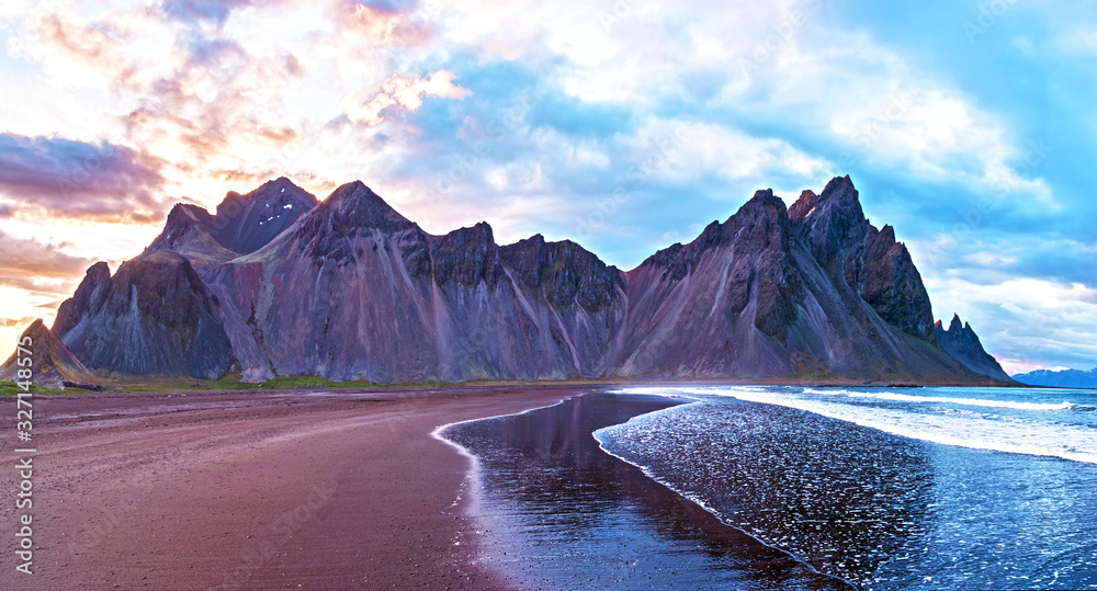 Scenic landscape with most breathtaking mountains Vestrahorn on the Stokksnes peninsula with the waves of the by in Iceland. Exotic countries. Amazing places.