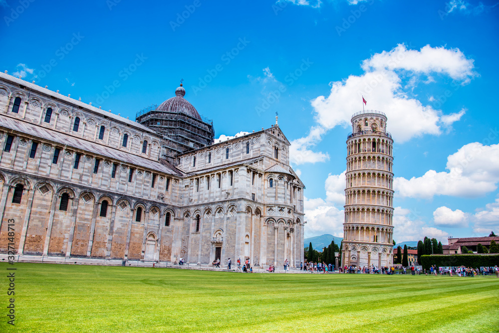 Picturesque landscape with San Giovanni Baptistery, part of cathedral or Duomo di Santa Maria Assunta near famous Leaning Tower in Pisa, Italy. fascinating exotic amazing places. Piazza dei Miracoli.