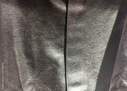 Silver shiny heat protective thermal clothing texture background macro closeup detail shot. Protection against fire and heat, safety work wear, security and fireproof material pattern abstract concept