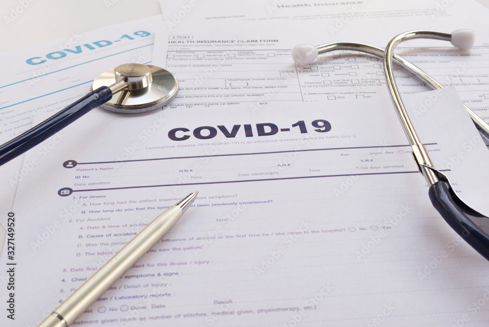 COVID-19 Health insurance concept. Stethoscope and pen on health insurance form COVID-19 Health insurance concept. Stethoscope and pen on health insurance form