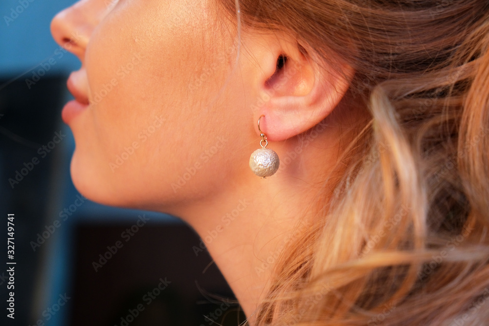 girl in beautiful round earrings on her ears