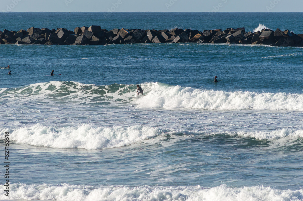 Sport surfing on the beach of zurriola located in san sebastian spain