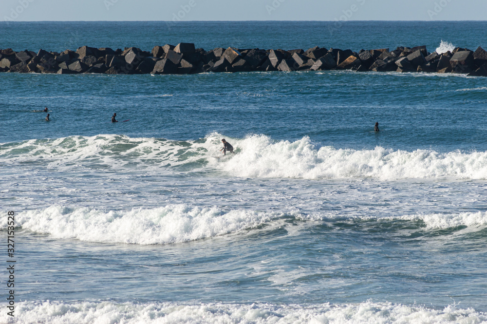 Sport surfing on the beach of zurriola located in san sebastian spain Sport surfing on the beach of zurriola located in san sebastian spain