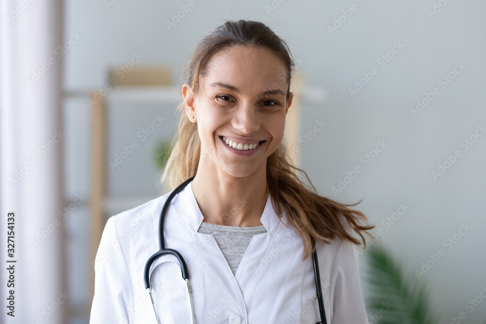 Head shot portrait smiling mixed race female doctor in uniform Head shot portrait smiling mixed race female doctor in uniform