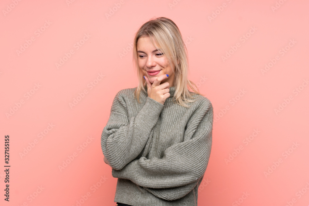Young blonde Russian woman over isolated pink background looking to the side Young blonde Russian woman over isolated pink background looking to the side