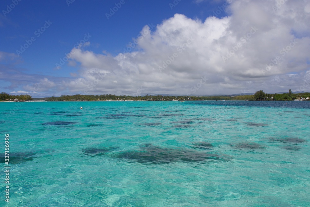 Tropical turquoise sea water and blue cloudy sky, Mauritius 