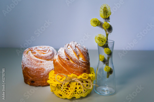 Cake kraffin (craffin) with powdered sugar and branch of willow on the table photo