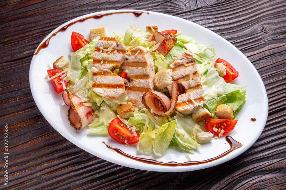 Caesar salad on dark wooden rustic background Caesar salad on dark wooden rustic background