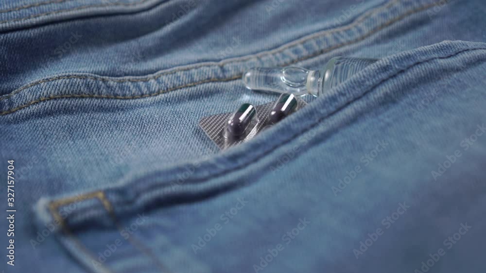 Blister pack with gray and green capsules and an injection ampoule in ...