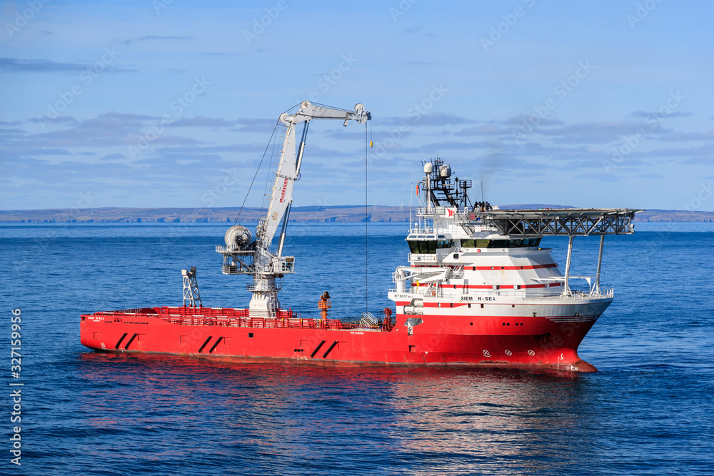 WICK, SCOTLAND - 2017 MARCH 23. Offshore crane vessel Siem N Sea with the crane high above the deck.