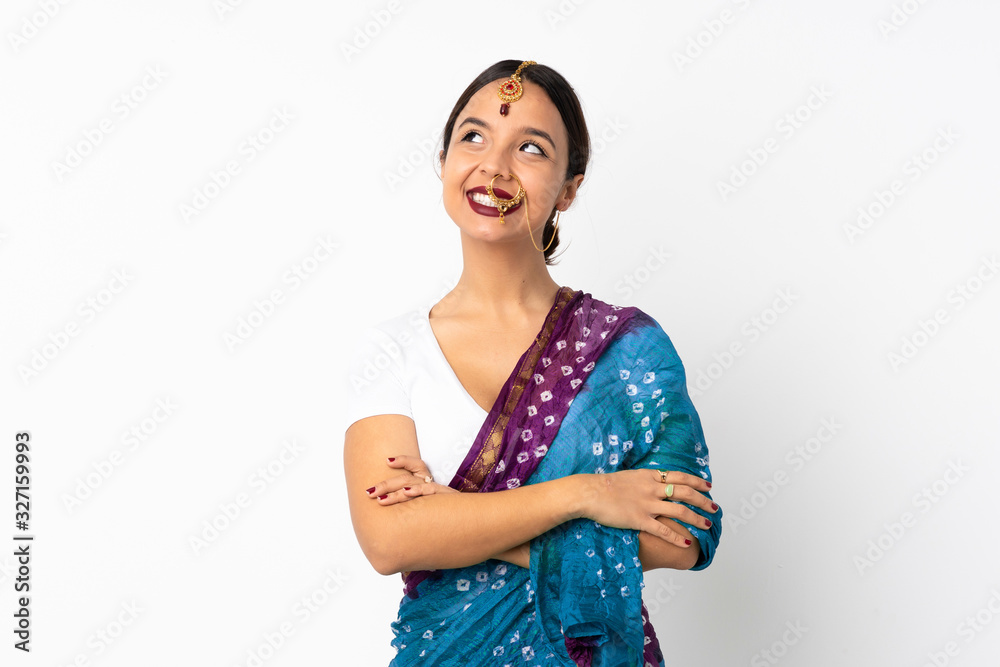Young indian woman isolated on white background looking up while smiling Young indian woman isolated on white background looking up while smiling