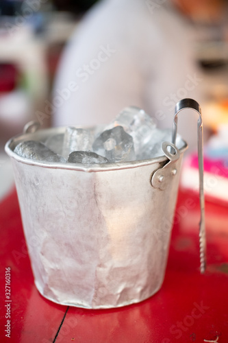 Ice cube in metal bucket