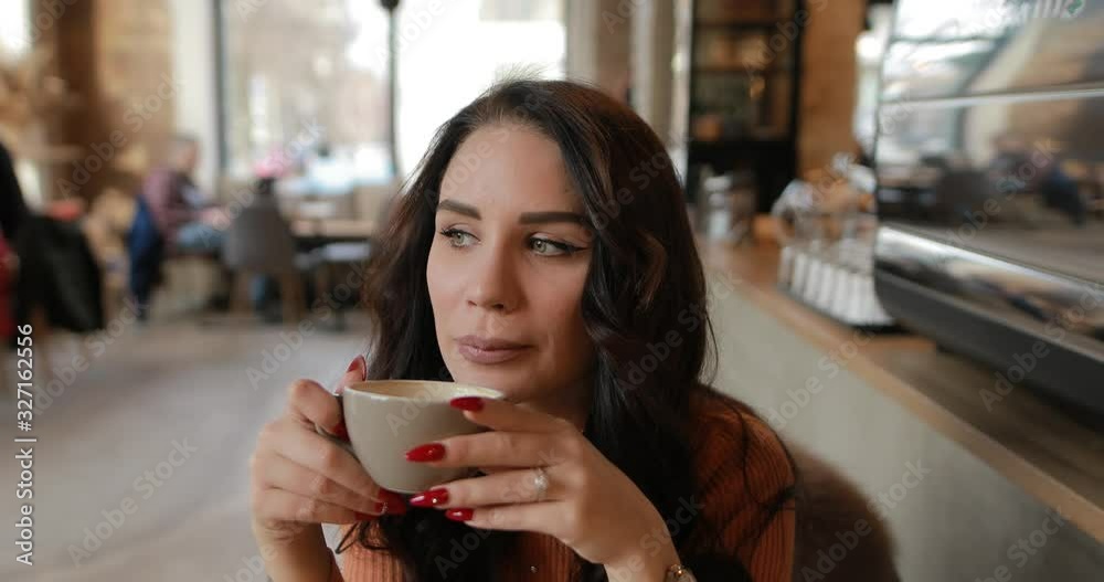 Woman enjoy drinking cup of coffee or other caffeine beverage in cafe Woman enjoy drinking cup of coffee or other caffeine beverage in cafe