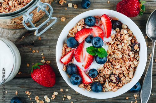 Healthy breakfast granola with fresh strawberry and blueberry. photo
