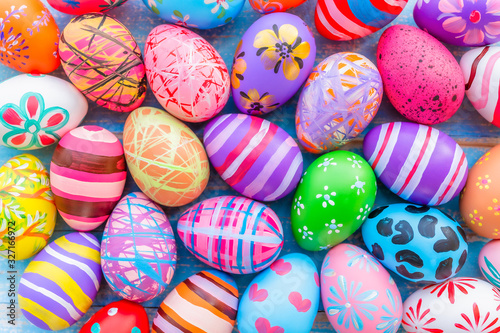 Beautiful colorful easter eggs on blue wooden photo