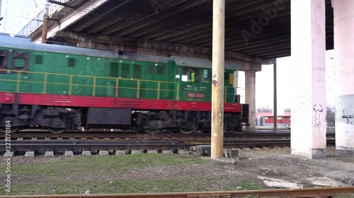 Railway track under the bridge. Drives a locomotive, train. The train passes under the bridge photo