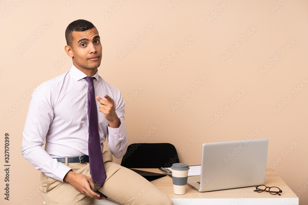 Young business man in a office points finger at you Young business man in a office points finger at you